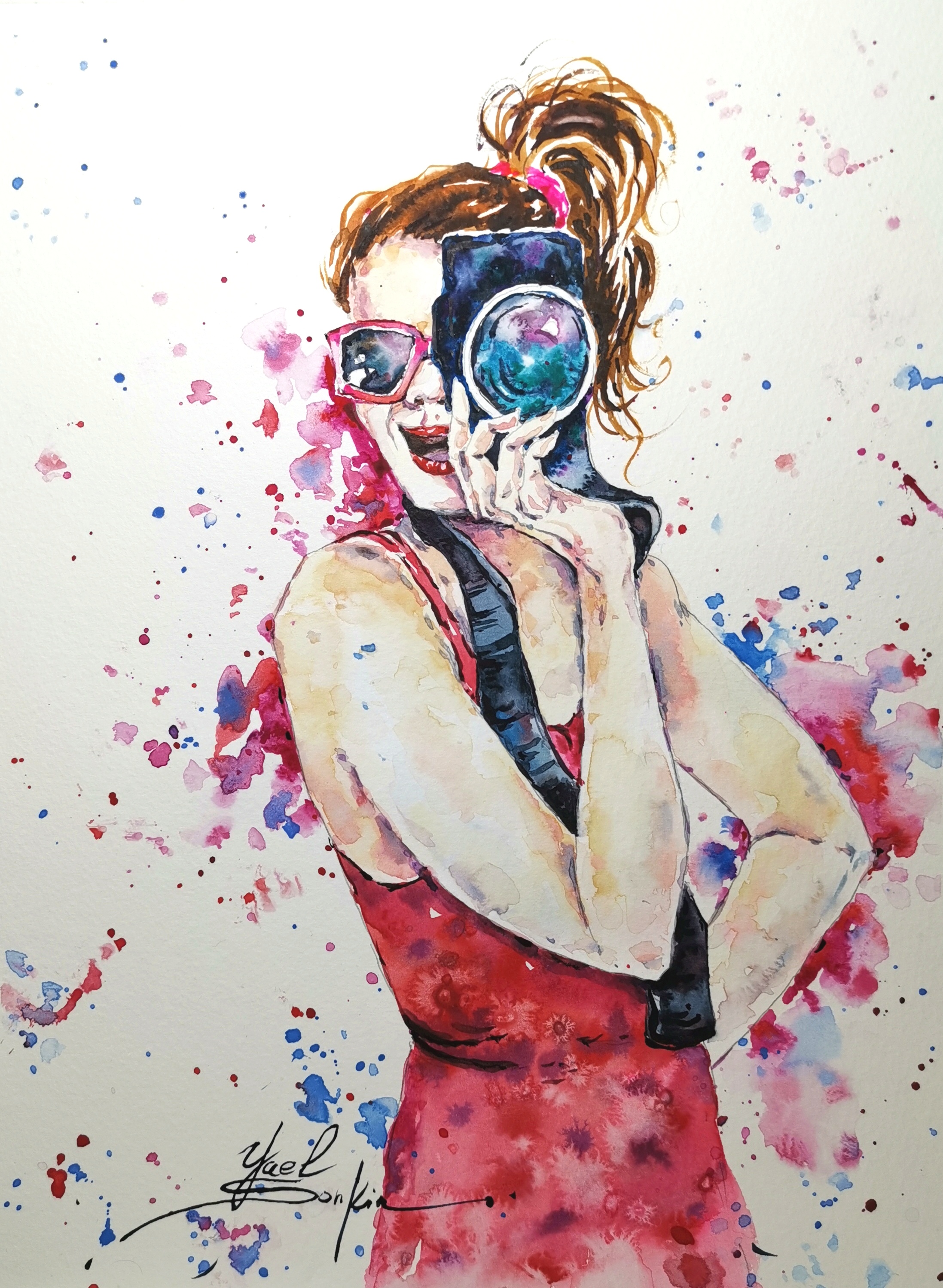 original watercolor painting of a girl photographer in red dress holding a camera, modern portrait wall art with colorful splashes, handmade artwork by Yael Natali, 13x10 inches